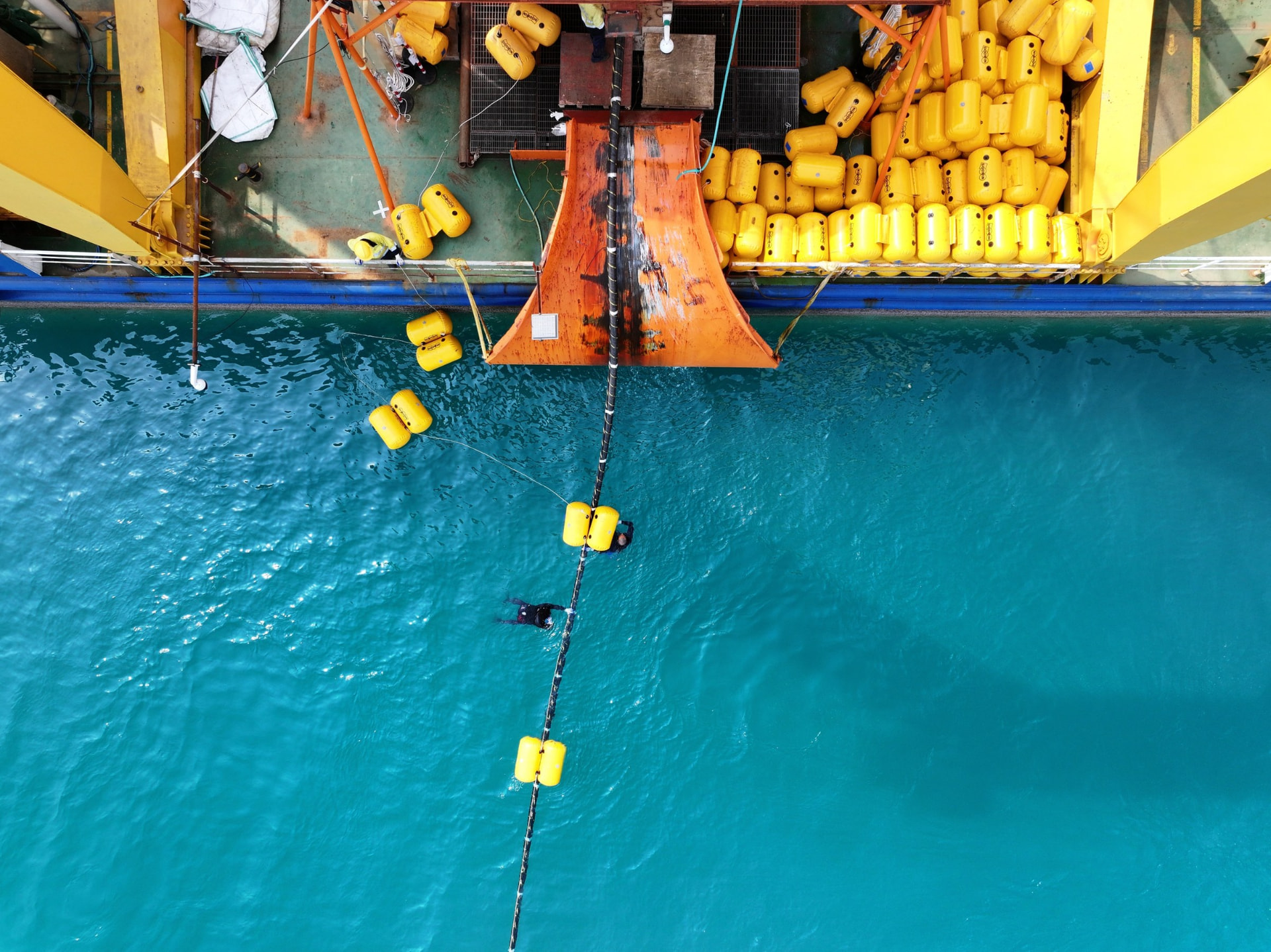 Cable deployment over the stern chute with floatation modules attached.