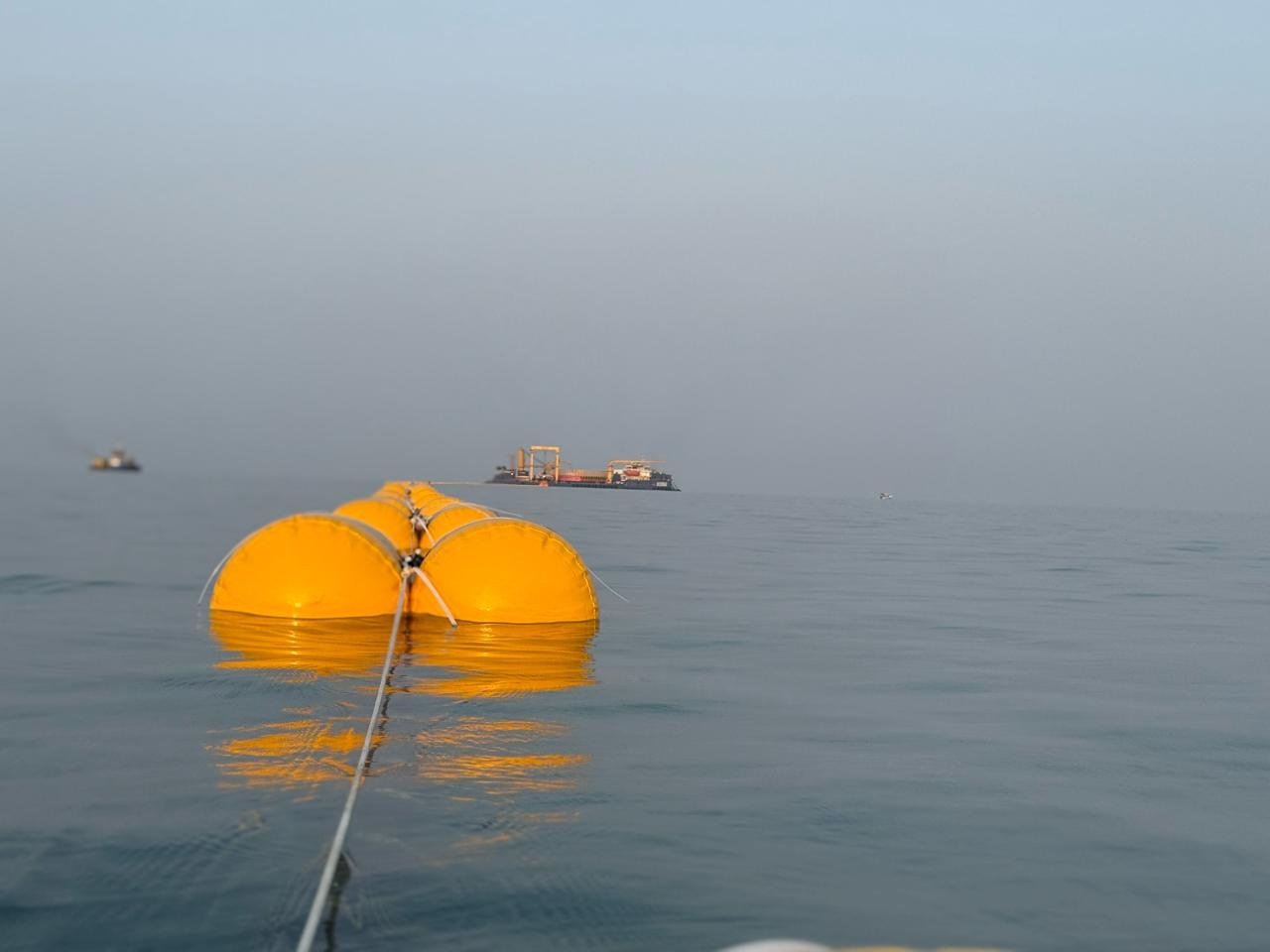 Floated line under tow at first light. Surface floats hold the section before controlled lay-down.