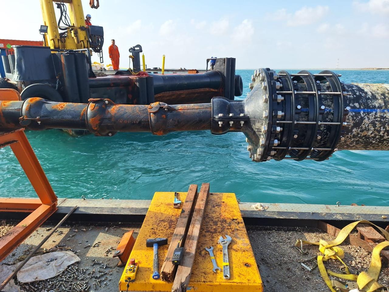 Flange coupling made up between new and recovered pipe sections.